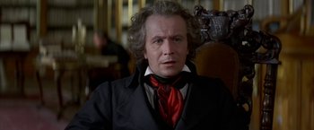 Movie still from “Immortal Beloved” (1994), directed by Bernard Rose – A person wearing a suit and tie; Close Up shot, Over the shoulder angle