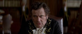 Movie still from “Immortal Beloved” (1994), directed by Bernard Rose – An older man wearing a black and gold jacket; Close Up shot, Over the shoulder angle
