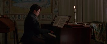 Movie still from “Immortal Beloved” (1994), directed by Bernard Rose – A man sitting at a piano in front of a sheet of music; Medium shot, Over the shoulder angle