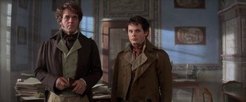 Movie still from “Immortal Beloved” (1994), directed by Bernard Rose – A man in brown jacket standing next to another man in brown jacket; Medium shot, Low angle