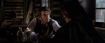 Movie still from “Immortal Beloved” (1994), directed by Bernard Rose – A man sitting at a table with a glass of wine; Close Up shot, Over the shoulder angle
