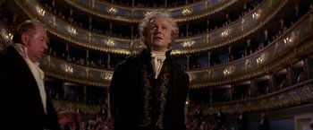 Movie still from “Immortal Beloved” (1994), directed by Bernard Rose – A man in a black jacket standing in front of an audience; Medium shot, Low angle
