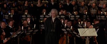 Movie still from “Immortal Beloved” (1994), directed by Bernard Rose – An old man standing in front of a group of people with candles; Medium shot, High angle