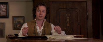 Movie still from “Immortal Beloved” (1994), directed by Bernard Rose – A man sitting at a table in front of papers; Close Up shot, Over the shoulder angle