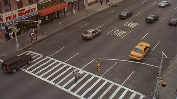 Movie still from “In America” (2002), directed by Jim Sheridan – An overhead view of a crosswalk with cars driving down it; Extreme Wide shot, High angle