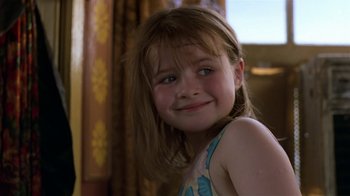 Movie still from “In America” (2002), directed by Jim Sheridan – A little girl with long brown hair and blue eyes; Close Up shot, Over the shoulder angle
