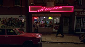 Movie still from “In America” (2002), directed by Jim Sheridan – People walk on the sidewalk in front of a diner; Extreme Wide shot, High angle