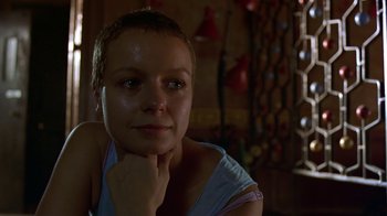 Movie still from “In America” (2002), directed by Jim Sheridan – A woman sitting in front of a mirror with her chin resting on her hand; Close Up shot, Low angle