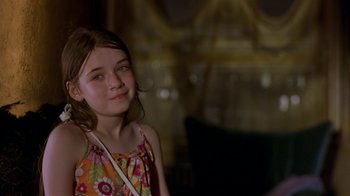 Movie still from “In America” (2002), directed by Jim Sheridan – A young girl is smiling for the camera; Close Up shot, Over the shoulder angle