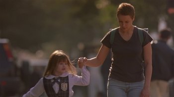 Movie still from “In America” (2002), directed by Jim Sheridan – A woman holding the hand of a little girl; Medium shot, Over the shoulder angle