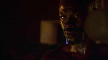 Movie still from “In America” (2002), directed by Jim Sheridan – A man's face in the dark; Close Up shot, Low angle