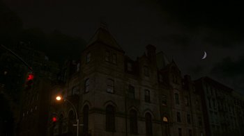 Movie still from “In America” (2002), directed by Jim Sheridan – A building that has been lit up at night time; Extreme Wide shot, Low angle