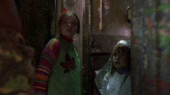 Movie still from “In America” (2002), directed by Jim Sheridan – Two young girls standing next to each other in a room; Medium shot, Low angle