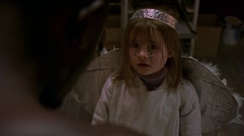 Movie still from “In America” (2002), directed by Jim Sheridan – A little girl wearing a silver crown and angel wings; Close Up shot, Over the shoulder angle