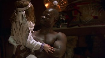 Movie still from “In America” (2002), directed by Jim Sheridan – A man holding a woman's hand in a room; Medium shot, Over the shoulder angle