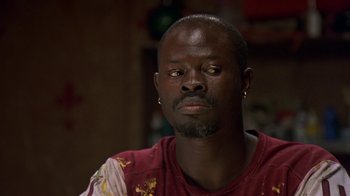 Movie still from “In America” (2002), directed by Jim Sheridan – A person wearing a red shirt; Close Up shot, High angle