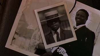 Movie still from “In America” (2002), directed by Jim Sheridan – An old photo of a man wearing a hat; Extreme Close Up shot, Overhead angle