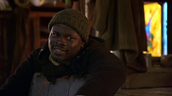 Movie still from “In America” (2002), directed by Jim Sheridan – A man wearing a green hat and a black jacket; Close Up shot, High angle