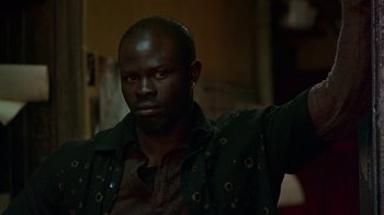 Movie still from “In America” (2002), directed by Jim Sheridan – A man with a beard and a jacket on; Close Up shot, Low angle