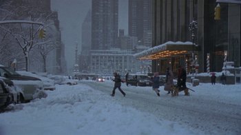 Movie still from “In America” (2002), directed by Jim Sheridan – A group of people walking down a snow covered street; Extreme Wide shot, High angle