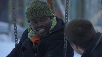 Movie still from “In America” (2002), directed by Jim Sheridan – A man wearing a green hat and a black jacket; Close Up shot, Over the shoulder angle