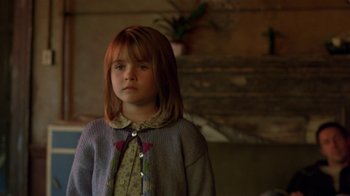 Movie still from “In America” (2002), directed by Jim Sheridan – A little girl standing in front of a fireplace; Close Up shot, Over the shoulder angle
