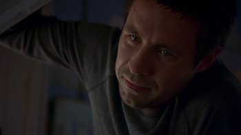 Movie still from “In America” (2002), directed by Jim Sheridan – A person wearing a gray shirt; Close Up shot, Low angle