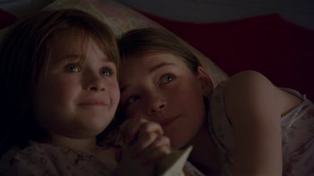 Movie still from “In America” (2002), directed by Jim Sheridan – Two young girls laying in a bed together; Close Up shot, High angle