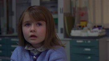 Movie still from “In America” (2002), directed by Jim Sheridan – A little girl sitting in front of a desk; Close Up shot, Over the shoulder angle