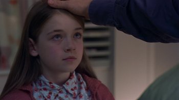 Movie still from “In America” (2002), directed by Jim Sheridan – A young girl getting her hair cut by a barber; Close Up shot, Over the shoulder angle