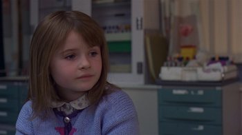 Movie still from “In America” (2002), directed by Jim Sheridan – A little girl sitting in front of a table; Close Up shot, Over the shoulder angle