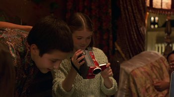 Movie still from “In America” (2002), directed by Jim Sheridan – A boy and a little girl looking at a camera; Close Up shot, Over the shoulder angle