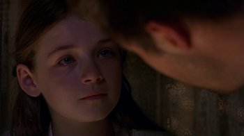 Movie still from “In America” (2002), directed by Jim Sheridan – A young girl looking at a man in a dark room; Close Up shot, Over the shoulder angle
