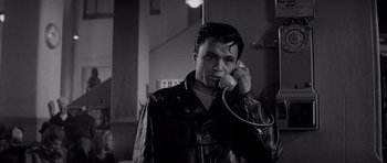 Movie still from “In Cold Blood” (1967), directed by Richard Brooks – A black and white photo of a man talking on a phone; Close Up shot, Low angle