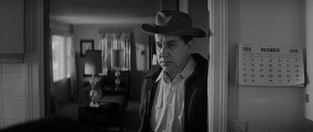 Movie still from “In Cold Blood” (1967), directed by Richard Brooks – An older man wearing a cowboy hat in a living room; Medium shot, Low angle