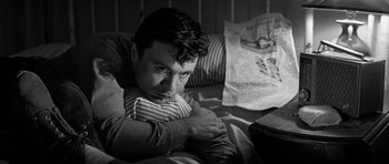 Movie still from “In Cold Blood” (1967), directed by Richard Brooks – A black and white photo of a man laying on a bed; Close Up shot, High angle