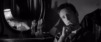 Movie still from “In Cold Blood” (1967), directed by Richard Brooks – A black and white photo of a man smoking a cigarette; Close Up shot, Low angle