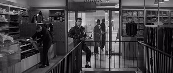 Movie still from “In Cold Blood” (1967), directed by Richard Brooks – Black and white photograph of a man in a leather jacket; Wide shot, Low angle