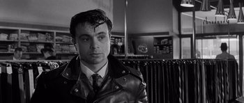 Movie still from “In Cold Blood” (1967), directed by Richard Brooks – Black and white photograph of a man wearing a leather jacket; Close Up shot, Over the shoulder angle
