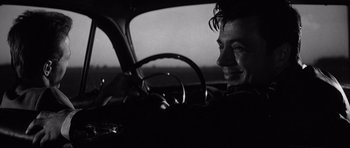 Movie still from “In Cold Blood” (1967), directed by Richard Brooks – A black and white photo of a man in the driver's seat of a car; Close Up shot, Over the shoulder angle