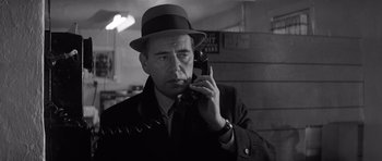 Movie still from “In Cold Blood” (1967), directed by Richard Brooks – A black and white photo of a man talking on a cell phone; Close Up shot, Low angle