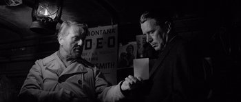 Movie still from “In Cold Blood” (1967), directed by Richard Brooks – Two men are looking at a piece of paper in front of them; Close Up shot, Over the shoulder angle