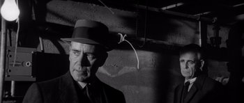 Movie still from “In Cold Blood” (1967), directed by Richard Brooks – An old man wearing a hat standing in front of a brick wall; Close Up shot, Low angle