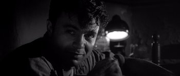 Movie still from “In Cold Blood” (1967), directed by Richard Brooks – Black and white photograph of a man holding a hammer; Close Up shot, Low angle