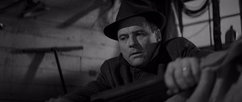 Movie still from “In Cold Blood” (1967), directed by Richard Brooks – A man wearing a hat and a jacket; Close Up shot, Low angle