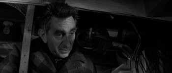 Movie still from “In Cold Blood” (1967), directed by Richard Brooks – A black and white photo of a man looking at the camera; Close Up shot, High angle