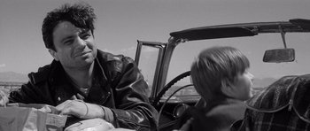 Movie still from “In Cold Blood” (1967), directed by Richard Brooks – A man sitting in the back of a car with a child; Close Up shot, Over the shoulder angle