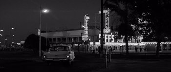 Movie still from “In Cold Blood” (1967), directed by Richard Brooks – A car parked on the side of the road at night; Wide shot, Low angle