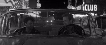 Movie still from “In Cold Blood” (1967), directed by Richard Brooks – Two young men in a car at night in the city; Medium shot, Over the shoulder angle