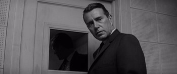 Movie still from “In Cold Blood” (1967), directed by Richard Brooks – Black and white photograph of a man in a suit and tie; Close Up shot, Low angle